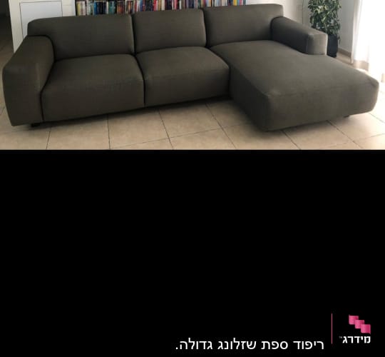 ספה מרופדת בצבע כהה עם כריות ישיבה